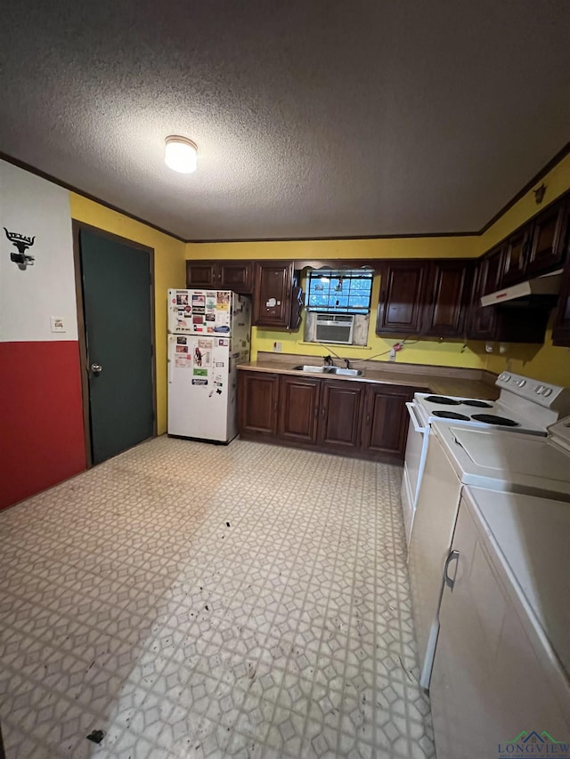 kitchen featuring dark brown cabinets, white appliances, a textured ceiling, sink, and washing machine and dryer