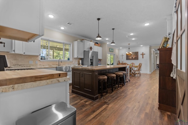 1767 County Road 3840, Hawkins, TX 75765 - kitchen featuring butcher block counters, high quality fridge, ornamental molding, a sink, and healthy amount of natural light