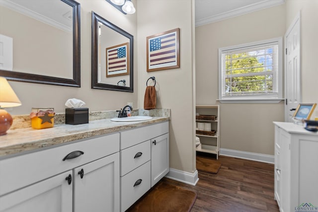 1767 County Road 3840, Hawkins, TX 75765 - bathroom with ornamental molding, toilet, vanity, wood finished floors, and baseboards