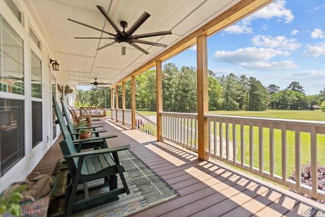 1767 County Road 3840, Hawkins, TX 75765 - wooden deck with a porch, a ceiling fan, a yard, and view of wooded area