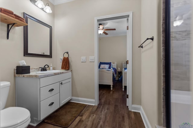 1767 County Road 3840, Hawkins, TX 75765 - bathroom with crown molding, wood finished floors, toilet, ceiling fan, and vanity
