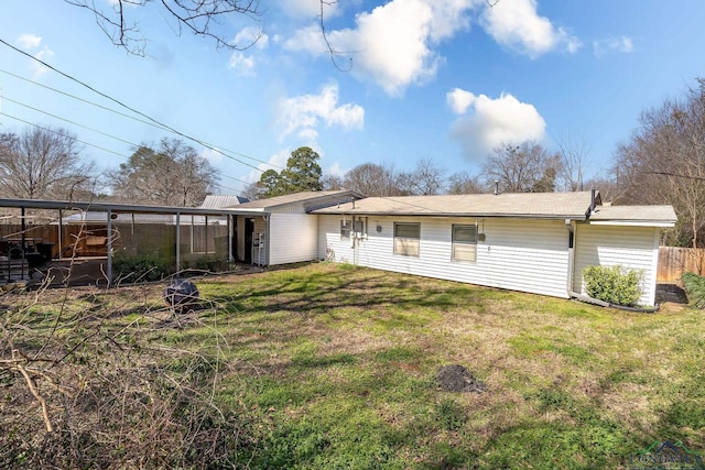 back of house featuring fence and a yard