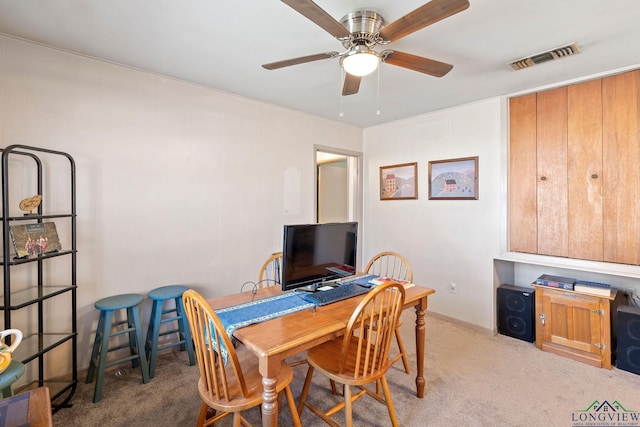 dining space with ceiling fan, carpet, and visible vents