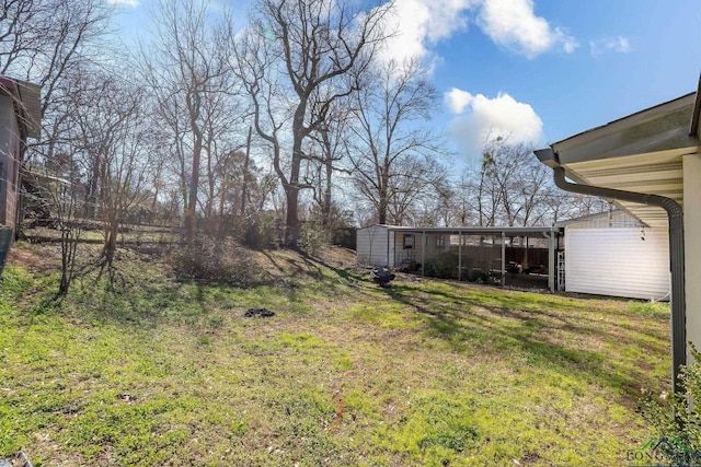 view of yard with an outbuilding and a storage shed