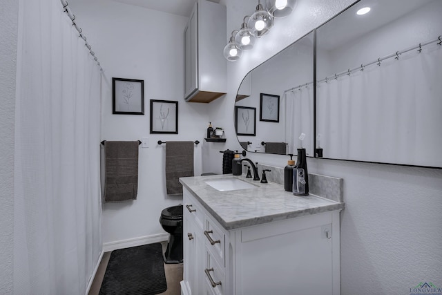 bathroom featuring vanity and toilet