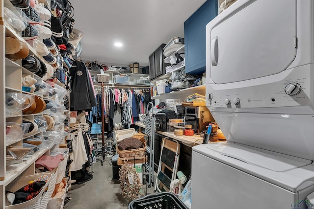 washroom featuring stacked washer / drying machine