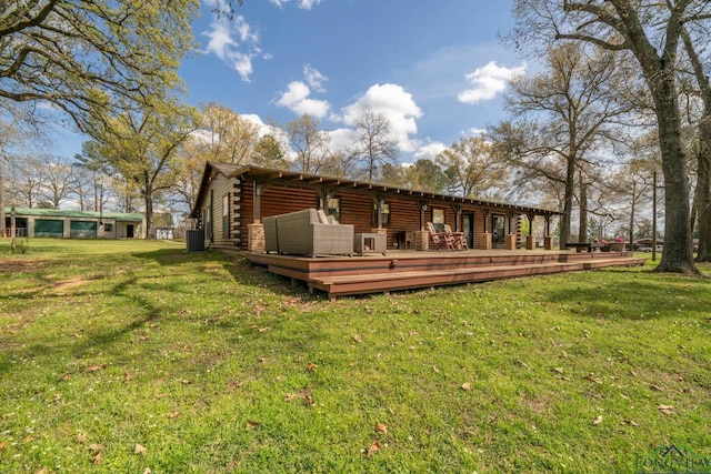 back of property with a lawn, cooling unit, and a wooden deck