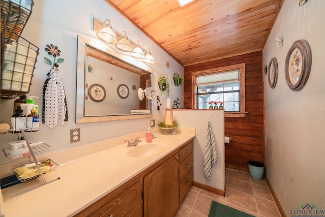 bathroom with wooden walls, tile patterned flooring, vanity, and wood ceiling