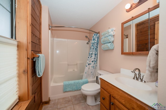 full bathroom with tile patterned floors, vanity, a textured ceiling, shower / tub combo with curtain, and toilet