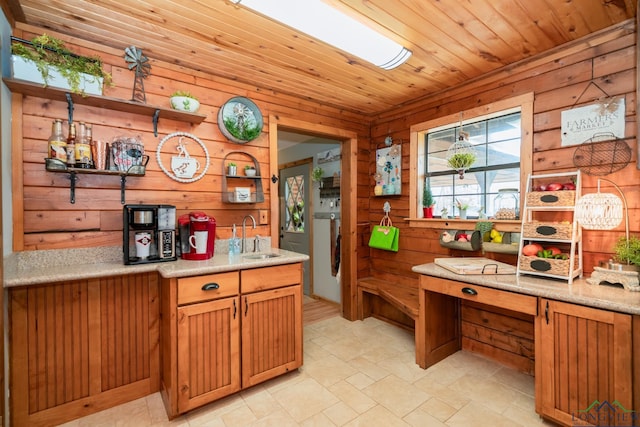 kitchen with wooden walls, sink, and wood ceiling