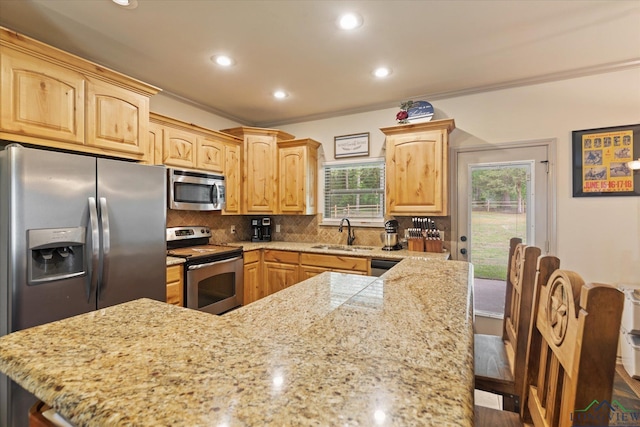 kitchen featuring light brown cabinets, crown molding, a sink, appliances with stainless steel finishes, and recessed lighting