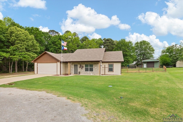 ranch-style home with fence, an attached garage, a front lawn, and driveway
