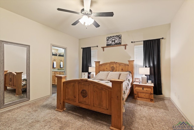 bedroom featuring ensuite bath, carpet floors, and ceiling fan