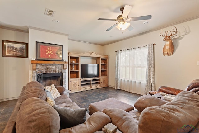 living room featuring ceiling fan, a fireplace, baseboards, ornamental molding, and visible vents
