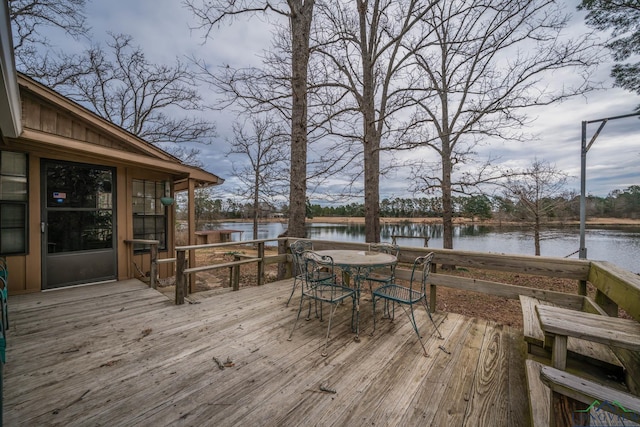 deck featuring a water view and outdoor dining area