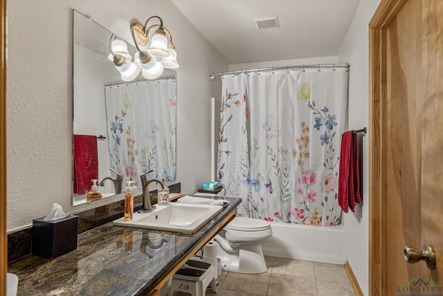 full bathroom with shower / bath combo, sink, a chandelier, tile patterned flooring, and toilet