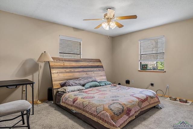 carpeted bedroom featuring a textured ceiling and ceiling fan