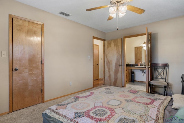 bedroom featuring ceiling fan, sink, and light carpet