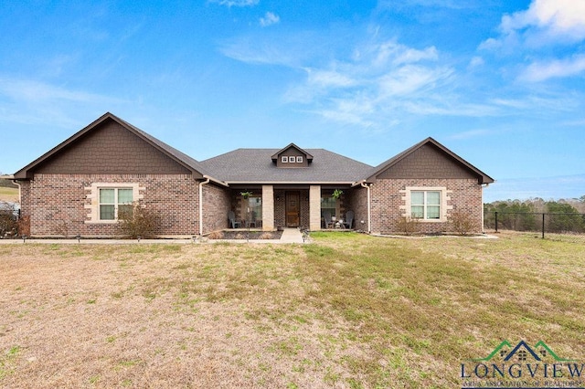 single story home with brick siding, fence, and a front lawn