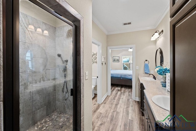 full bathroom featuring visible vents, wood finished floors, ensuite bathroom, crown molding, and a sink