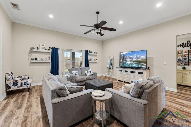 living room featuring ornamental molding, recessed lighting, wood finished floors, and baseboards