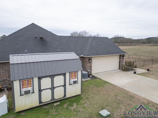 view of front of property with brick siding, a shingled roof, fence, driveway, and a front lawn