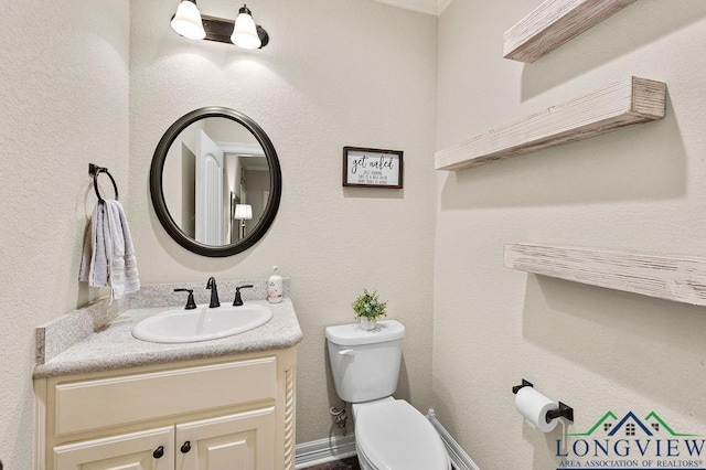 bathroom with toilet and vanity