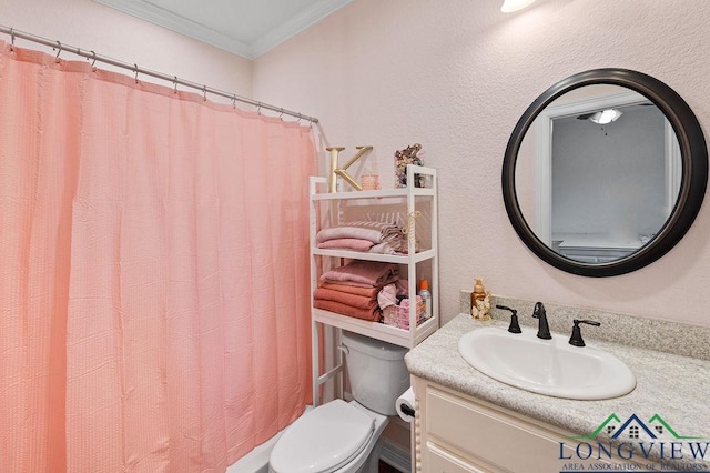 bathroom with toilet, ornamental molding, and vanity