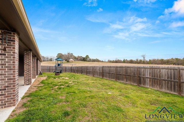 view of yard featuring a fenced backyard and a playground