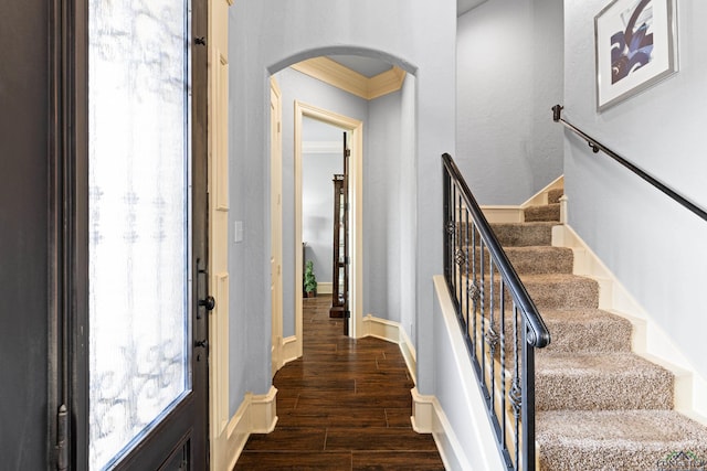 1600 Olympic Dr, Longview, TX 75605 - entrance foyer featuring arched walkways, ornamental molding, dark wood-style flooring, stairway, and plenty of natural light