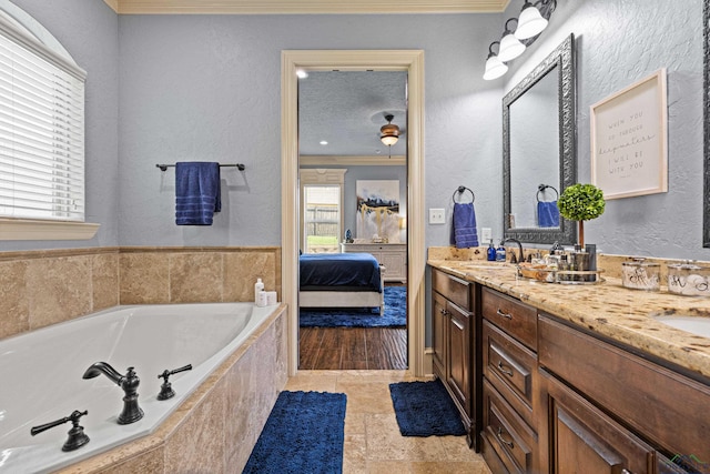 1600 Olympic Dr, Longview, TX 75605 - ensuite bathroom featuring double vanity, a bath, and a textured wall