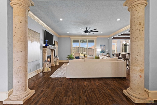 1600 Olympic Dr, Longview, TX 75605 - living area with ornate columns, ceiling fan, crown molding, dark wood finished floors, and a textured ceiling