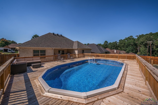 view of pool with a wooden deck