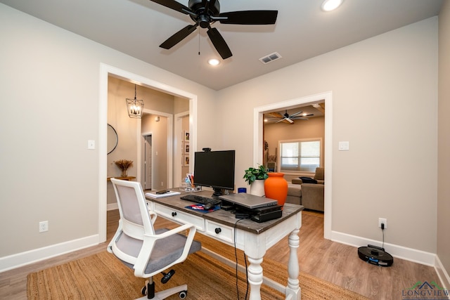 office area featuring light hardwood / wood-style flooring and a notable chandelier