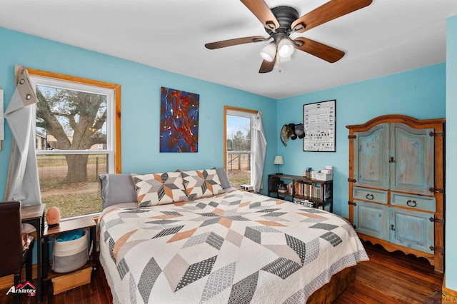 bedroom with dark wood-type flooring and ceiling fan