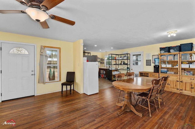 dining room with dark hardwood / wood-style flooring and ceiling fan