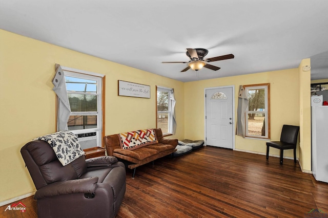 living room with ceiling fan, a healthy amount of sunlight, and dark hardwood / wood-style flooring