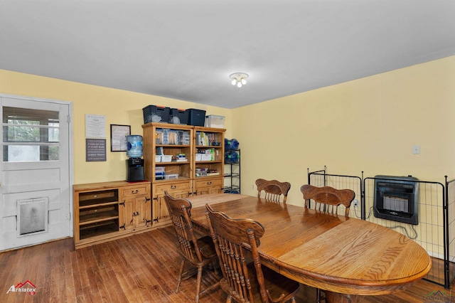 dining area featuring heating unit and dark wood-type flooring