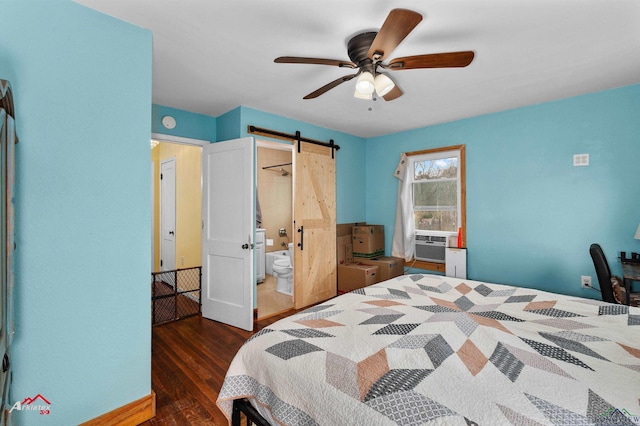 bedroom featuring connected bathroom, cooling unit, dark hardwood / wood-style flooring, ceiling fan, and a barn door