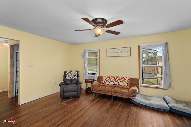 living room featuring dark hardwood / wood-style floors and ceiling fan