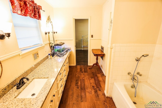 bathroom with wood-type flooring, vanity, and ornamental molding