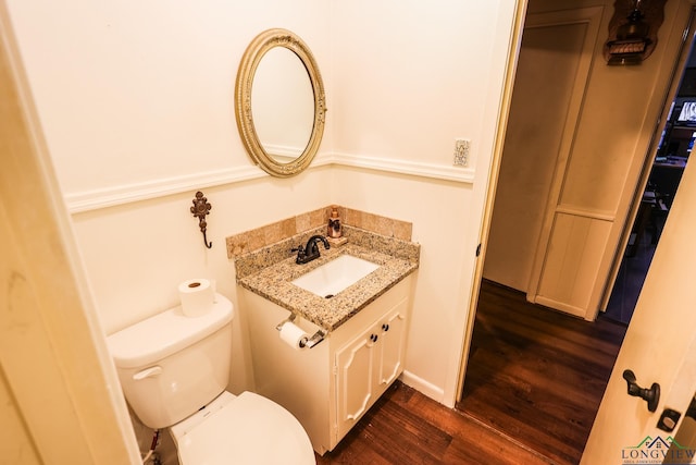 bathroom with vanity, wood-type flooring, and toilet