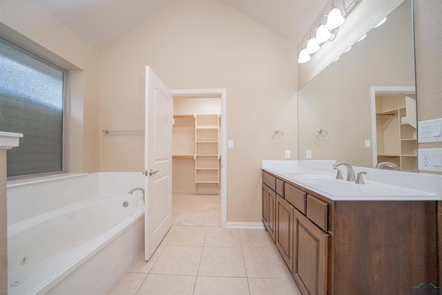 2532 Windmill Ln, Longview, TX 75601 - bathroom with vanity, a spacious closet, a garden tub, lofted ceiling, and tile patterned floors