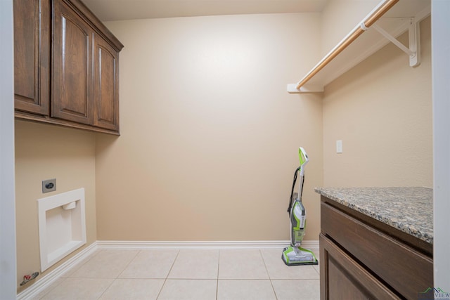 2532 Windmill Ln, Longview, TX 75601 - washroom with hookup for an electric dryer, cabinet space, and light tile patterned floors
