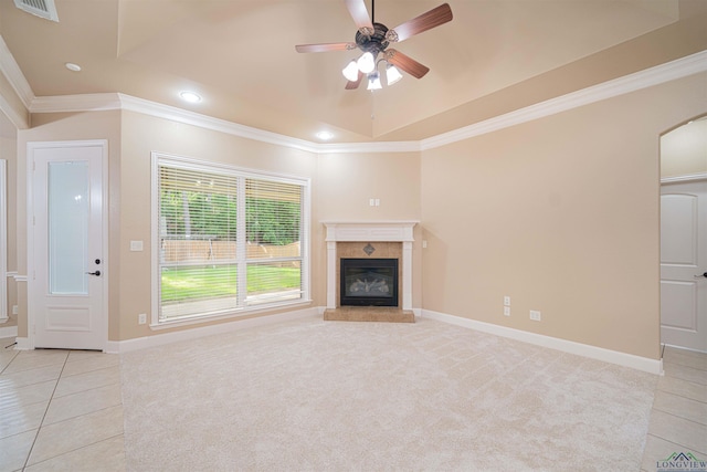 2532 Windmill Ln, Longview, TX 75601 - unfurnished living room with crown molding, light tile patterned floors, a tile fireplace, a raised ceiling, and ceiling fan