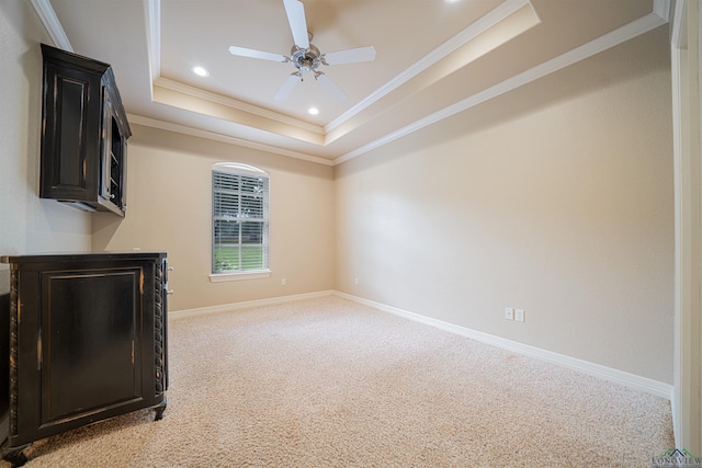 bedroom featuring baseboards, a raised ceiling, light colored carpet, crown molding, and recessed lighting