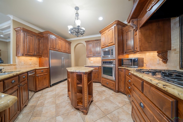 kitchen featuring ornamental molding, arched walkways, light stone countertops, and built in appliances