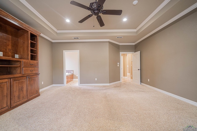 unfurnished bedroom with baseboards, a raised ceiling, and light colored carpet