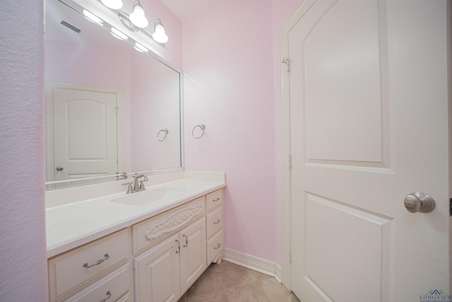 bathroom with tile patterned flooring, visible vents, vanity, and baseboards