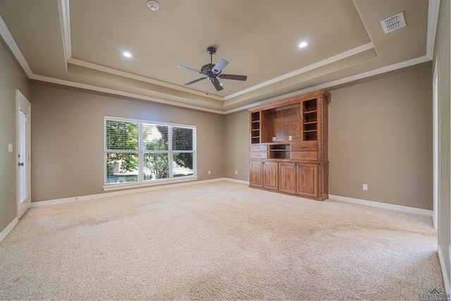 unfurnished living room with a raised ceiling, visible vents, light carpet, and baseboards